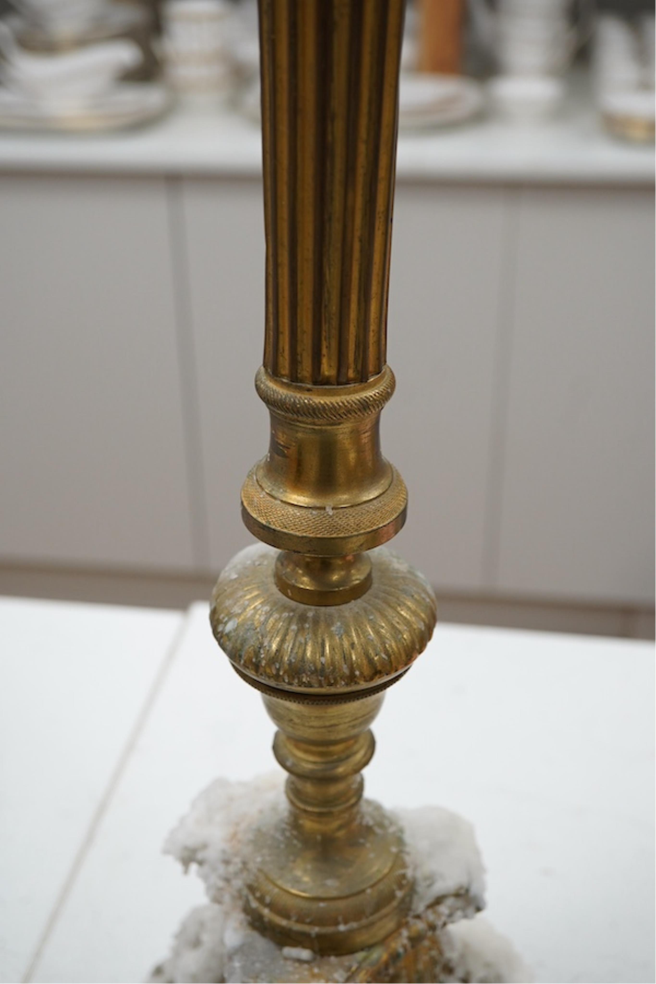 A brass column candlestick, 73cm